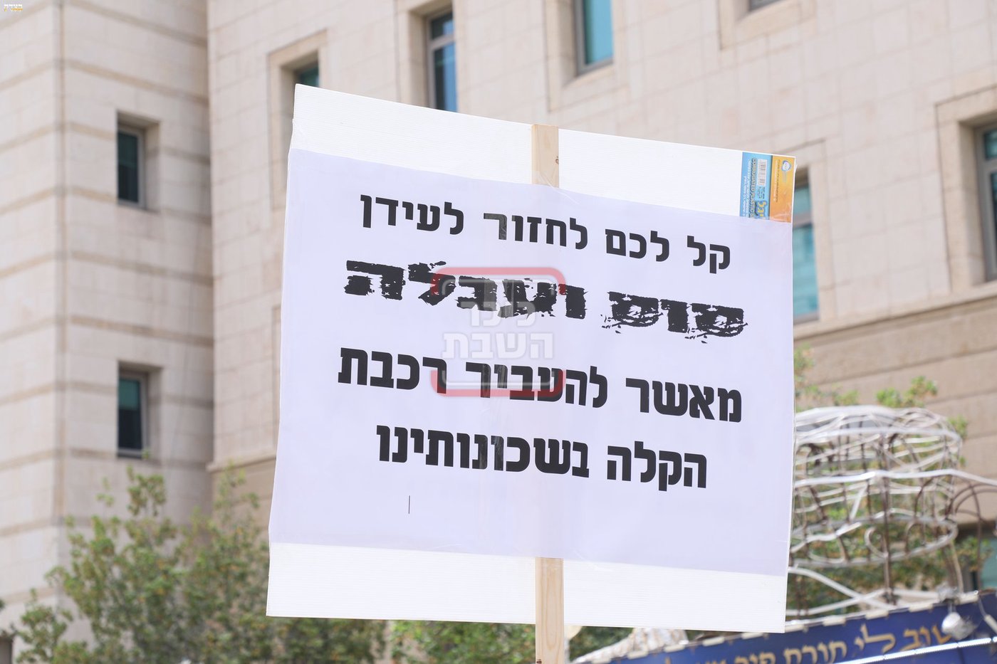 שלטי המחאות בהפגנה נגד רכבת הקלה