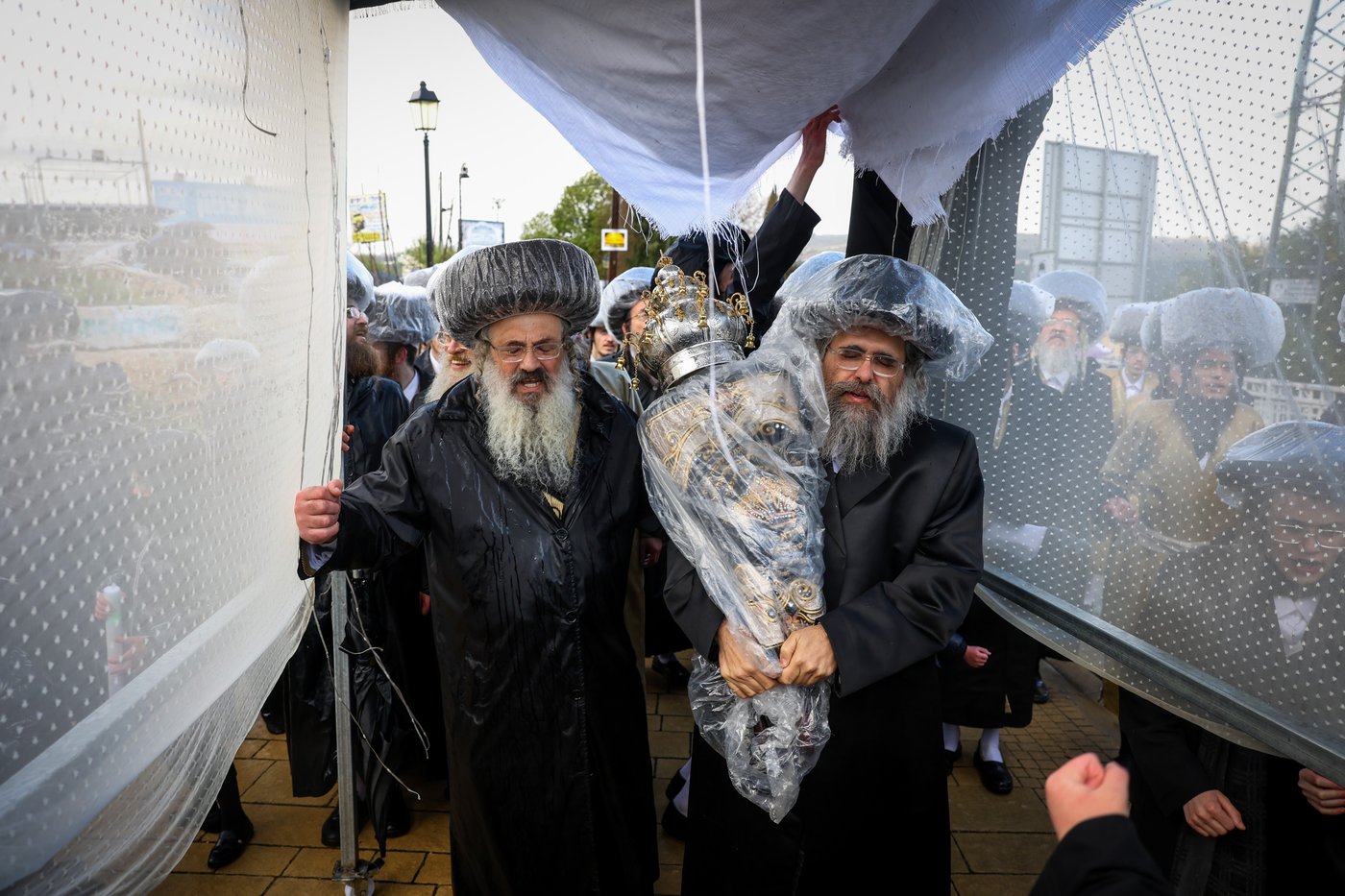 חסידי תולדות אהרון בהכנסת ספר תורה תחת גשם שוטף בציון הרשב"י במירון