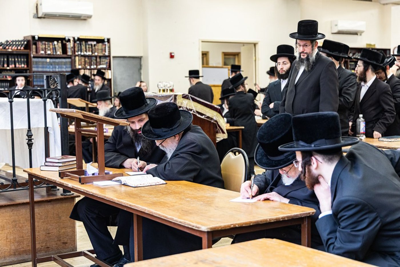 חסידי באבוב 45 נותנים קוויטלעך לרבם לפני המסע לצאנז